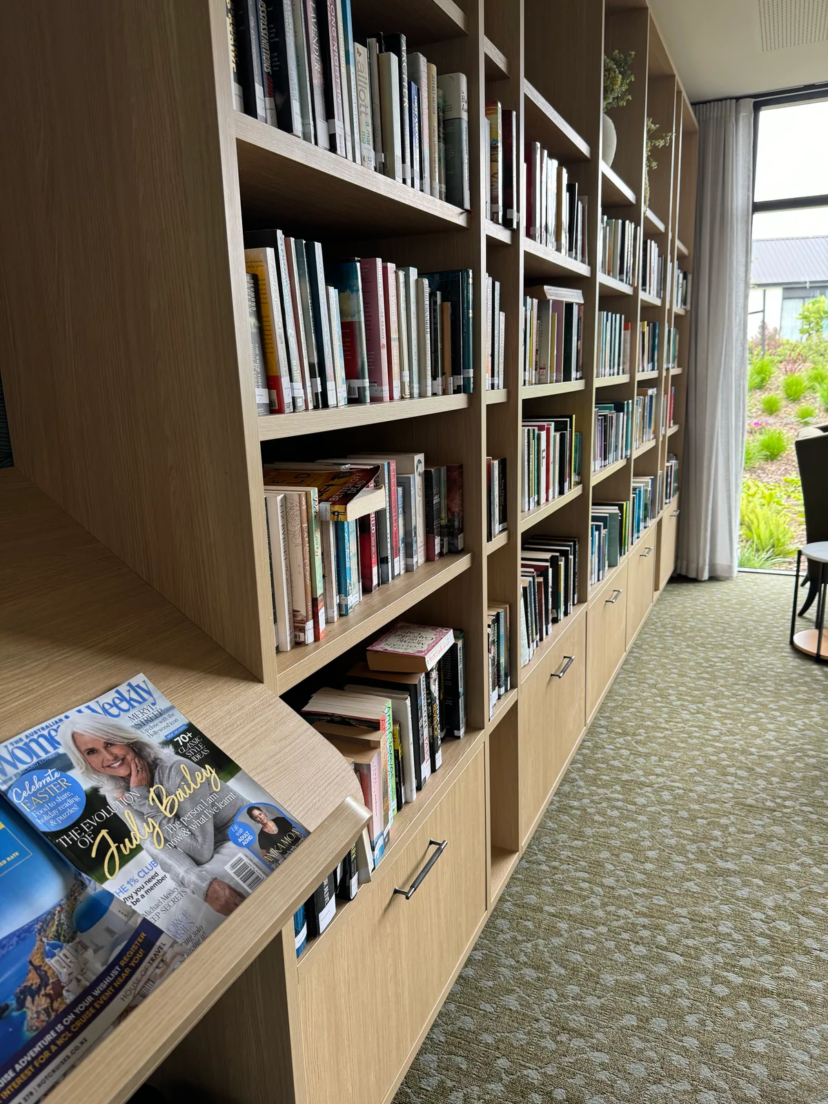 Long view along the custom timber library shelving and integrated cabinetry