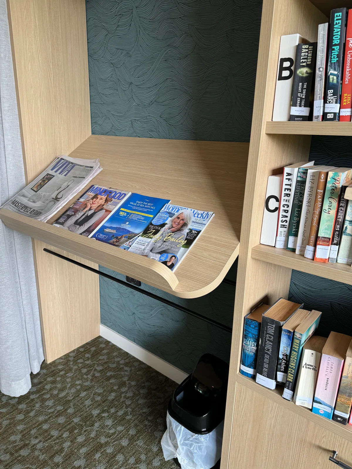 Integrated library reading desk with curved timber edge and patterned wall lining