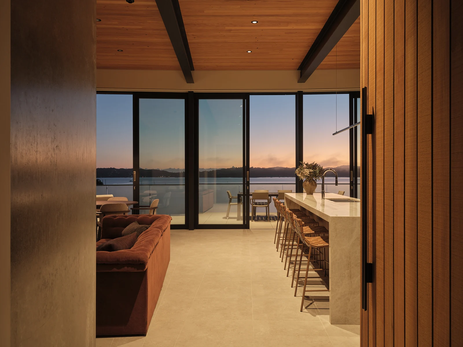 The same view along the School Road island before dawn, with the kitchen lights glowing