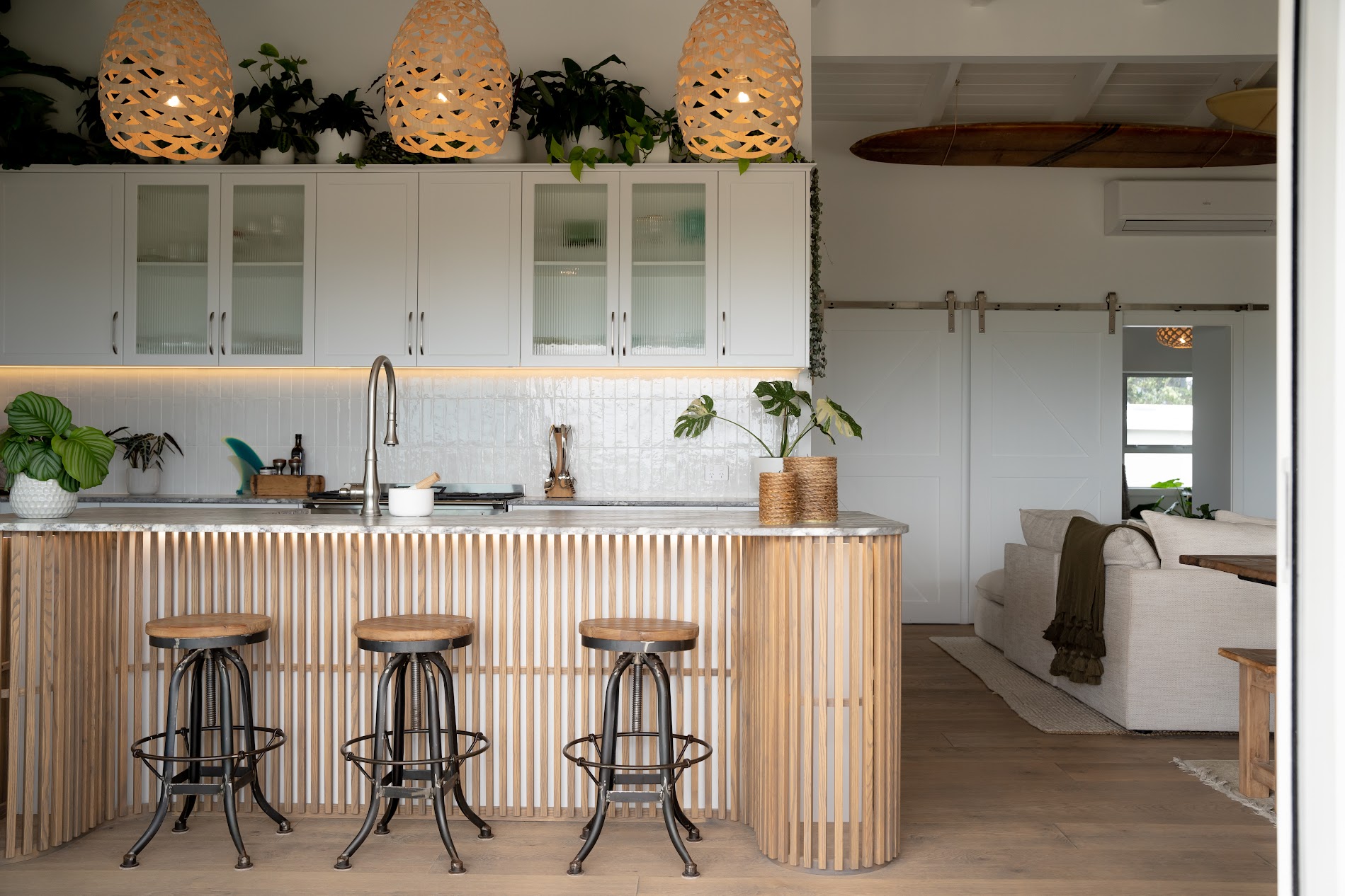 Custom white kitchen with a curved timber-slat island, designed and made by North Interiors