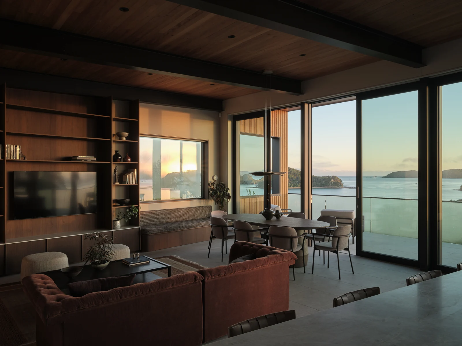 Sunrise on the living display wall and window seat seen from the kitchen